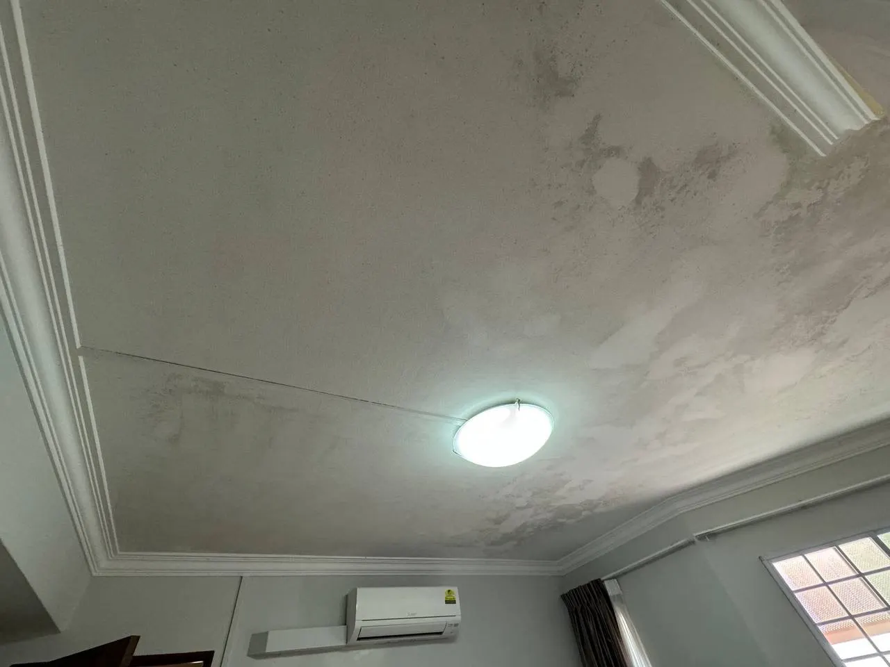 Mold affected corridor ceiling before treatment